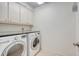 Clean laundry room with granite countertop over LG washer and dryer and storage cabinets at 2072 Middleburg Ln, Mount Pleasant, SC 29464