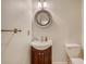 Cozy powder room featuring a pedestal sink, round mirror, and neutral tones at 2072 Middleburg Ln, Mount Pleasant, SC 29464
