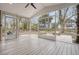 Spacious screened porch with wooden floors overlooking the backyard and play set at 2072 Middleburg Ln, Mount Pleasant, SC 29464