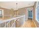 Upstairs landing boasts hardwood floors, with natural light and views into connecting rooms at 2072 Middleburg Ln, Mount Pleasant, SC 29464