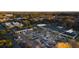Expansive aerial view of neighborhood retail with plentiful parking surrounded by trees and neighborhood residences at 2200 Belle Isle Ave # 103, Mount Pleasant, SC 29464