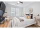 Cozy bedroom with natural light, a ceiling fan, and a navy accent wall at 2200 Belle Isle Ave # 103, Mount Pleasant, SC 29464