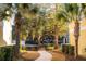 Landscaped walkway leading to condo buildings with lush trees and well-maintained shrubs at 2200 Belle Isle Ave # 103, Mount Pleasant, SC 29464