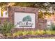 Welcome to One Belle Hall Condominiums sign made of brick with palm tree art, in the middle of well manicured landscaping at 2200 Belle Isle Ave # 103, Mount Pleasant, SC 29464