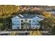 Beautiful three-story building with colorful facade, lush landscaping and a convenient parking area at 2200 Belle Isle Ave # 103, Mount Pleasant, SC 29464