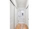 Bright hallway with hardwood floors, closets, and a bathroom featuring marble tile and a tub-shower combo at 2200 Belle Isle Ave # 103, Mount Pleasant, SC 29464