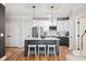 Modern kitchen features white cabinets, stainless steel appliances, a large island, and stylish pendant lighting at 2200 Belle Isle Ave # 103, Mount Pleasant, SC 29464