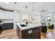 Open concept kitchen view to living area and dining, with a white quartz island and stainless appliances at 2200 Belle Isle Ave # 103, Mount Pleasant, SC 29464