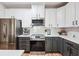 Modern kitchen with stainless appliances, gray base cabinets, subway tile backsplash and white countertops at 2200 Belle Isle Ave # 103, Mount Pleasant, SC 29464