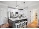 Bright kitchen with white cabinets, stainless steel appliances, an island with bar seating, and hardwood floors at 2200 Belle Isle Ave # 103, Mount Pleasant, SC 29464