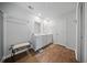Bright bathroom with double sinks, wood look flooring, and a decorative bench at 225 Sedona Dr, Summerville, SC 29486
