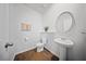 The half bathroom is styled with a modern, pedestal sink and white fixtures at 225 Sedona Dr, Summerville, SC 29486