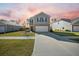 Charming two-story home featuring a manicured lawn and attached two-car garage with neutral color scheme at 225 Sedona Dr, Summerville, SC 29486