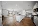 Open-concept living space with hardwood floors, featuring a modern kitchen island and stainless steel appliances at 225 Sedona Dr, Summerville, SC 29486