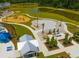 Community playground featuring playground equipment, picnic tables, lounge chairs, and a splash pad at 225 Sedona Dr, Summerville, SC 29486