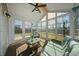 Bright sunroom filled with natural light, features wicker furniture, and serene backyard views at 225 Sedona Dr, Summerville, SC 29486