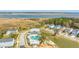 Community aerial view featuring homes, clubhouse, pool, playground, marshland, and bridge at 2322 Dorado Ct, Johns Island, SC 29455