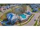 Aerial view featuring the community pool, clubhouse, pond, and well-maintained landscaping at 2322 Dorado Ct, Johns Island, SC 29455