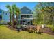 Landscaped backyard featuring a fire pit and covered porch at 2322 Dorado Ct, Johns Island, SC 29455