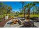 Beautiful backyard with patio, fire pit, lounge chairs, and view of the serene pond at 2322 Dorado Ct, Johns Island, SC 29455