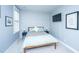 Cozy bedroom with light blue paneled walls, a TV, and a comfortable bed with blue accents at 2322 Dorado Ct, Johns Island, SC 29455