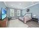 Calming bedroom with two windows, light blue walls, and a walk in closet at 2322 Dorado Ct, Johns Island, SC 29455
