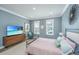 Comfortable bedroom features two bright windows, modern furnishings, and neutral tones, perfect for relaxation at 2322 Dorado Ct, Johns Island, SC 29455