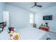 Bright bedroom with white walls, ceiling fan, TV, and comfortable full bed with colorful stuffed animals at 2322 Dorado Ct, Johns Island, SC 29455