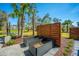Well-designed garden plot area featuring planter boxes, palm trees, and decorative privacy fence at 2322 Dorado Ct, Johns Island, SC 29455