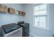 Laundry room with front loading washer and dryer and overhead storage at 2322 Dorado Ct, Johns Island, SC 29455