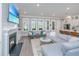 Inviting living room with a fireplace, large windows, and open layout to the kitchen at 2322 Dorado Ct, Johns Island, SC 29455