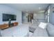 Open-concept living room featuring neutral tones, plush gray sofa, large television, and modern entertainment center at 2322 Dorado Ct, Johns Island, SC 29455