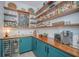 Organized pantry with custom shelves, vibrant teal cabinetry, and wine fridge, a culinary haven at 2322 Dorado Ct, Johns Island, SC 29455