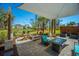 Inviting covered patio with stylish seating, a fire pit, and view of the neighborhood pond at 2322 Dorado Ct, Johns Island, SC 29455