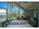 Outdoor screened-in porch with pond views, comfortable seating and beautiful string lights at 2322 Dorado Ct, Johns Island, SC 29455