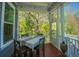 Outdoor screened-in porch with nature views and a table at 2322 Dorado Ct, Johns Island, SC 29455
