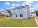 The backyard has a covered patio, lawn, and an energy-efficient air conditioning unit at 234 Silk Oak Dr, Moncks Corner, SC 29461