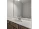 Bathroom sink with neutral cabinets, white countertops and a large mirror reflects the light, creating a bright and inviting space at 234 Silk Oak Dr, Moncks Corner, SC 29461
