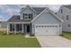 Charming two-story home with a two-car garage and well-manicured lawn at 234 Silk Oak Dr, Moncks Corner, SC 29461
