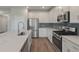 Open-concept kitchen with stainless appliances, large island, and white cabinetry at 234 Silk Oak Dr, Moncks Corner, SC 29461