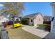 Private backyard featuring a charming yellow swing, stone walkway, and a detached garage at 2353 Eagle Creek Dr, Charleston, SC 29414