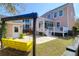 Charming backyard with a yellow swing, patio, and lush greenery, perfect for outdoor relaxation at 2353 Eagle Creek Dr, Charleston, SC 29414