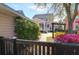 Secluded backyard with a yellow swing, mature trees, and manicured landscaping behind black fence at 2353 Eagle Creek Dr, Charleston, SC 29414