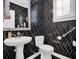 Chic half bathroom with modern sink, statement wallpaper and stylish fixtures at 2353 Eagle Creek Dr, Charleston, SC 29414