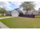 Charming home exterior featuring a well-maintained lawn, black fence, and a two-car garage at 2353 Eagle Creek Dr, Charleston, SC 29414