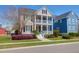 Charming two-story home featuring double balconies, well-manicured lawn, and a vibrant red front door at 2353 Eagle Creek Dr, Charleston, SC 29414