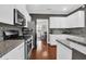 This kitchen has sleek appliances, granite countertops, gray backsplash, and open view to dining area at 2353 Eagle Creek Dr, Charleston, SC 29414