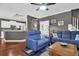 Open-concept living room features hardwood floors, comfortable sofas, and kitchen access at 2353 Eagle Creek Dr, Charleston, SC 29414