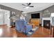 Inviting living room with hardwood floors, fireplace, TV, and stairs to second level at 2353 Eagle Creek Dr, Charleston, SC 29414