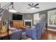 Cozy living room with fireplace, hardwood floors, ceiling fan and plenty of light at 2353 Eagle Creek Dr, Charleston, SC 29414